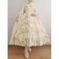 Detailed view of ornate Lolita dress featuring delicate lace trim, bows, and layered ruffled skirt. - S / Off White