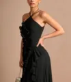 Detail view of the elegant black halter pleated maxi dress with chic ruffle trim and slim fit design. - XS / Black