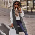 Detailed view of women's casual long hooded puffer vest in dark grey with knit sweater. - Dark Gray