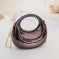 Crescent acrylic mini handbag with gold chain, stylish metallic shoulder bag for women. - Black