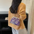 Elegante borsa a conchiglia viola ricamata con motivi floreali e chiusura dorata. - Viola (Manico in Metallo)