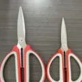 Dual-size kitchen scissors set with red white rubber handles and stainless steel blades. - Small 15cm