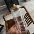 Transparent acrylic storage jar with wooden lid, clear cylindrical canister for home organization. - Dust-Proof Cup Holder