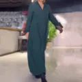 Detail view of the elegant solid teal V-neck long sleeve maxi dress in an indoor setting. - S / Green