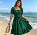 Green square neck short sleeve A-line dress detail shot showing elegant ruffle hem design. - Green
