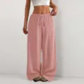 Detail view of women's solid color loose textured wide-leg casual pants with drawstring waist. - S / Pink