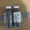 Cat litter deodorizer beads in clear plastic bottle with white cap, pet odor eliminator. - Activated Carbon