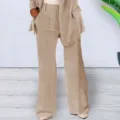 Detailed view of women's chic beige blazer and wide-leg trousers suit set, elegant style. - Apricot Pants / S