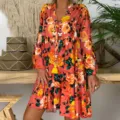 Detailed view of the vintage floral tiered dress featuring long sleeves and a relaxed bohemian hem. - S / Orange