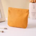 Yellow minimalist portable makeup pouch, squeeze lock cosmetic bag for daily use and travel. - Orange