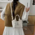 Small cream textured bucket bag featuring a silver star charm and crossbody strap - White + Pendant