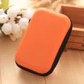 Orange mini hard shell storage pouch for earphones data cables and coins compact zipper design. - Orange
