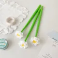 Close-up of three green silicone gel pens with decorative white lotus flower toppers. - 0.5mm (Black Ink) / White