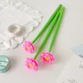 Three green silicone pens with realistic pink lotus flower toppers on a white desk - 0.5mm (Black Ink) / Rose Red