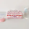 Detailed view of floral quilted pencil case featuring white lace trim and strawberry print - Berry Girl Cosmetic Bag