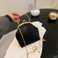 Black sequin kiss-lock shell bag with gold chain strap and ring handle - Black