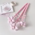 Close-up of three pink fabric flower gel pens featuring soft plush flower tops and stems. - 1PC / Pink