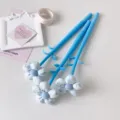 Close-up of blue pens featuring fabric flower toppers and creative stationery accessories - 1PC / Blue