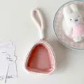 Detail of pink plush doll display bag with clear window and soft carrying strap - Pink