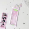 Detail view of a pink strawberry PVC photocard holder with cute star decorations. - Pink