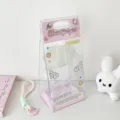 Close-up of clear PVC display bag with pink wings design for 10cm plush dolls - Pink