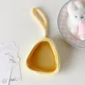 Close-up of plush yellow doll display pouch with clear window and loop handle - Yellow