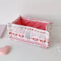Macro view of strawberry pattern fabric storage basket with lace trim and gingham lining - L / Red Strawberry