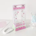 Close-up detail of the cute pink cake theme transparent PVC doll display and storage bag - Pink