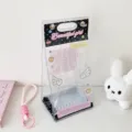 Close-up detail of a transparent 10cm cotton doll storage bag with pink angel wing prints - Black