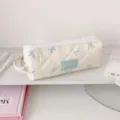 Detail of quilted fabric pencil case with blue bow pattern and Hisocute label - Light Yellow