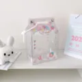 Detailed view of a cute transparent strawberry milk box PVC ita-bag for plush doll display - Pink