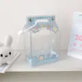 Detailed macro view of the cute blue checkered milk carton shaped plush doll display bag. - Blue