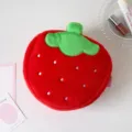 Macro detail of a plush strawberry-shaped makeup bag featuring soft red fuzzy texture. - Red Strawberry (Plush)