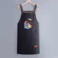 Waterproof oil-proof kitchen apron with pocket and cute cartoon print for cooking home work - Regular Fit / Black