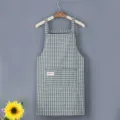 Cotton kitchen apron with plaid pattern and front pocket, perfect for cooking and baking. - Green