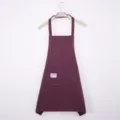 Dark red vertical striped kitchen apron with front pocket and wooden hanger display. - Red Halter Neck Style