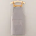 Grey kitchen apron with brown straps and front pocket, clean design for cooking and baking. - Gray