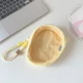 Close-up of cute plush doll storage bag showing dotted interior and wrist strap - Yellow