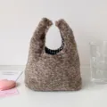 Detailed view of leopard print plush handbag showing soft texture and checkered lining - Brown