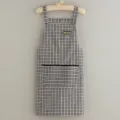Cotton kitchen apron with plaid pattern and pocket, breathable and stylish for cooking. - Black