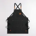 Schwarze Arbeits-Leinwand Schürze mit Kreuzgurten und Lederdetails, Stilvariante. - Schwarz