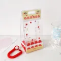 Close-up of strawberry cake patterned PVC doll display bag with red coil keychain accessory - Red
