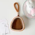 Close-up of brown plush doll display pouch with clear transparent window - Brown