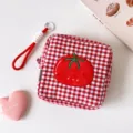 Detailed view of red and white checkered storage pouch with cute embroidered tomato motif - Short / Red