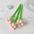 Close-up of three creative fabric flower pens with pink checkered petals - Orange Plaid