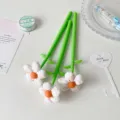 Close-up of creative fabric flower pens with green stems and plush blossoms - White Pony
