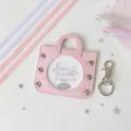 Close-up of pink mini handbag badge holder with decorative silver star accents - Including Four Ribbons in Two Colors / Pink