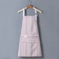Kitchen apron with vertical stripes, adjustable straps, and front pocket for cooking. - Coffee