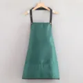 Dark green kitchen apron with black straps and pockets, durable workwear for cooking baking. - Green