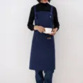 Dark blue work apron variant, featuring durable poly-cotton fabric, pockets, and comfortable straps. - Suspender Style / Blue